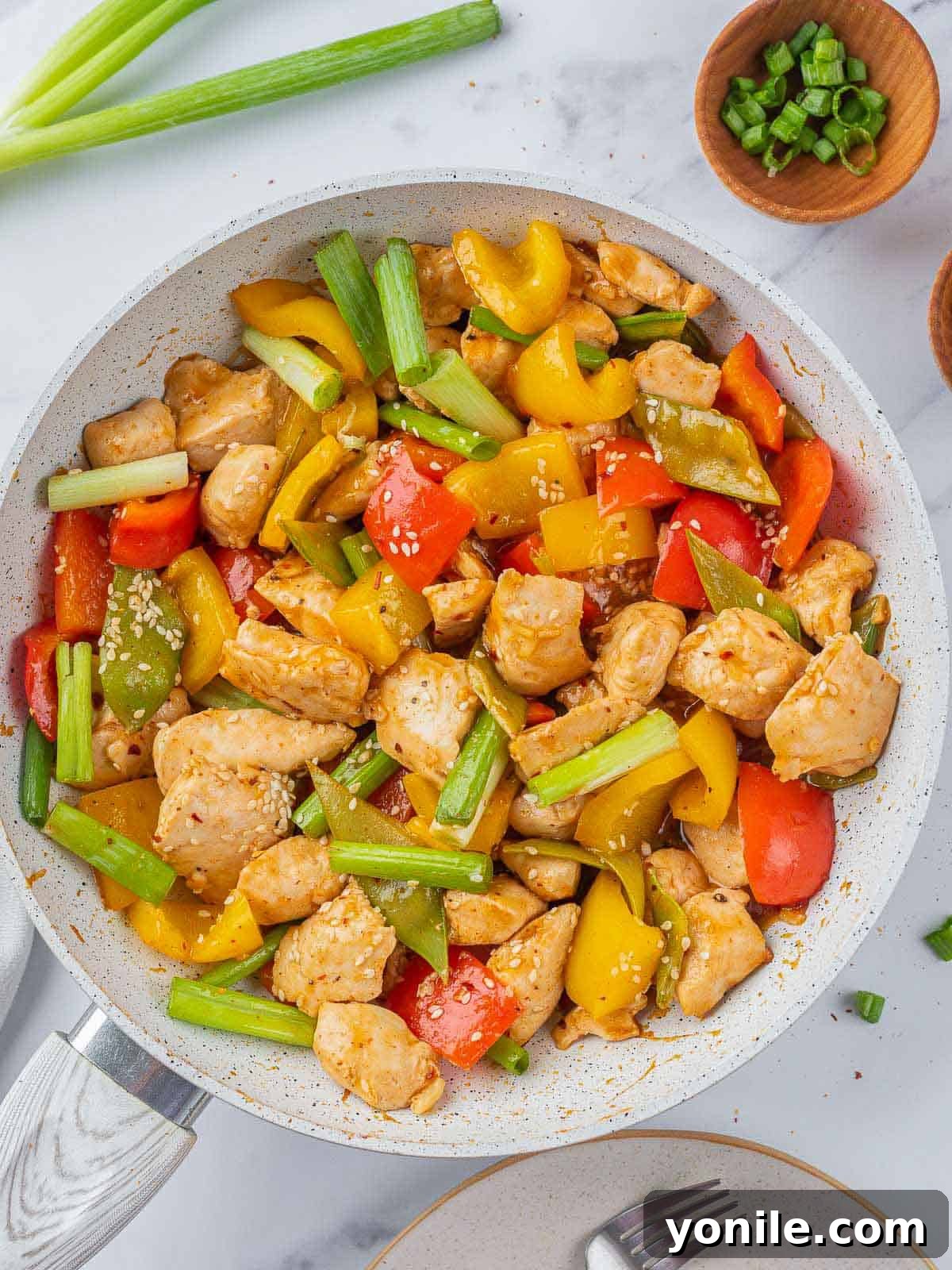 A large pan filled with the vibrant and saucy Szechuan chicken stir-fry.
