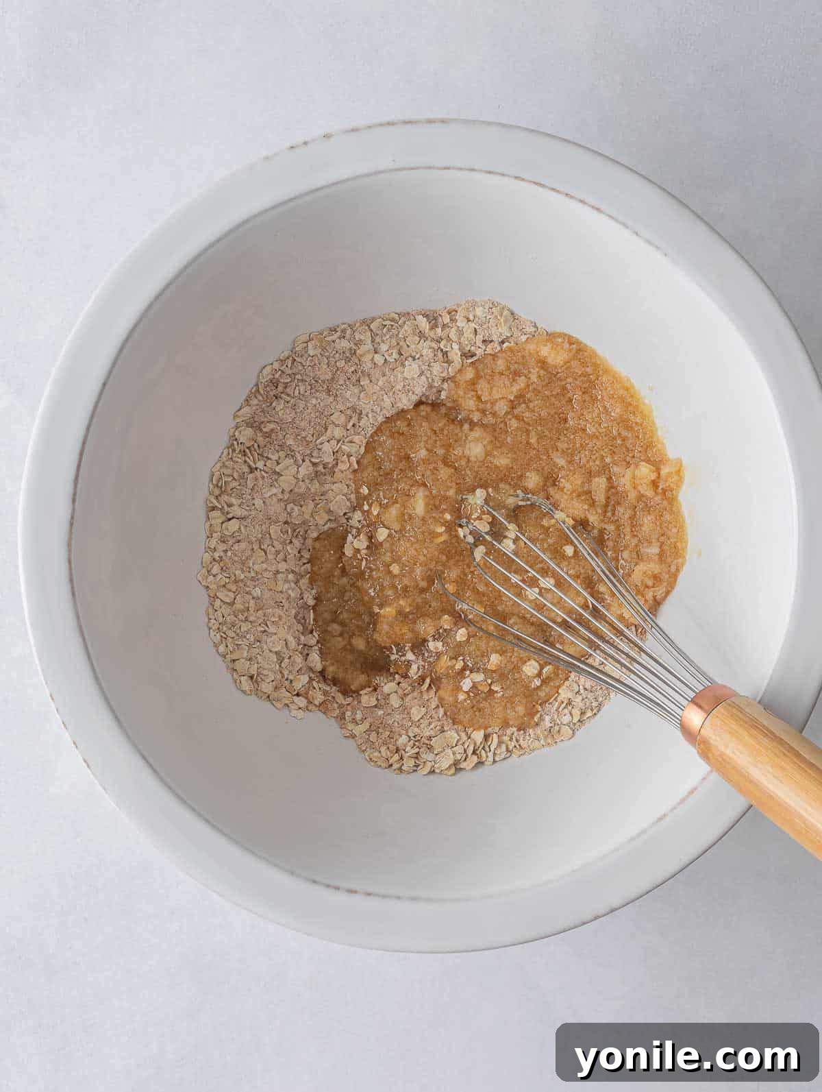 Separated bowls of wet and dry ingredients, ready to be combined for cookie dough.