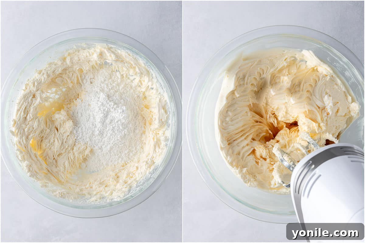 Butter and cream cheese being mixed together in a stand mixer bowl, starting the frosting process.