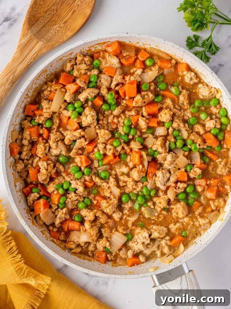 Delicious shepherds pie filling in a skillet, ready to be transferred