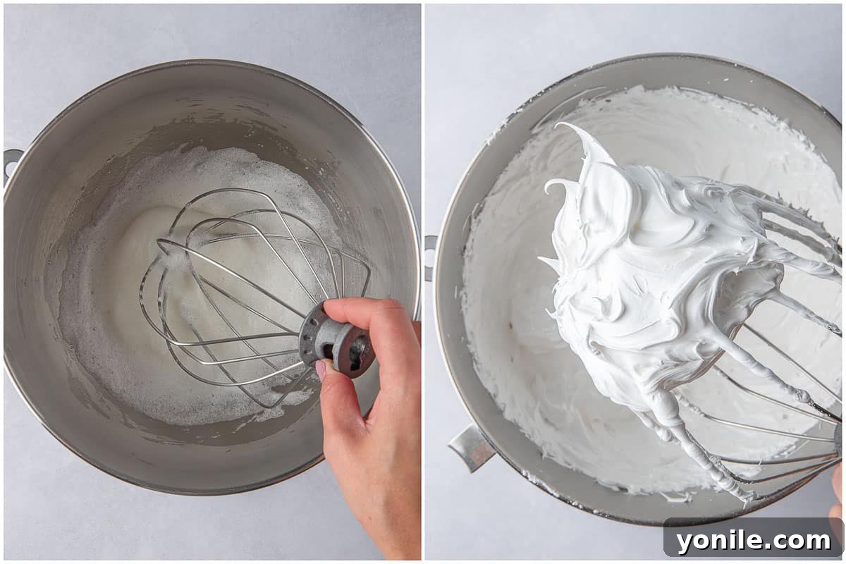 Egg whites being whisked in a large mixing bowl, showing the frothy stage of meringue preparation.
