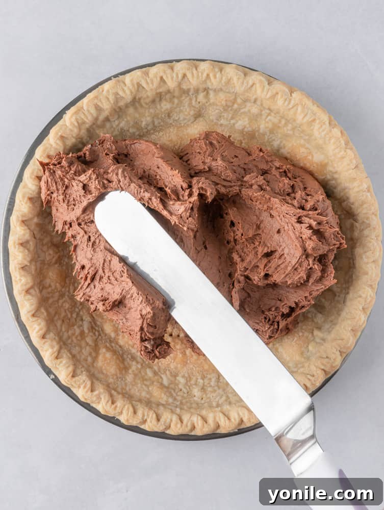 chocolate silk pie filling placed in the pie crust