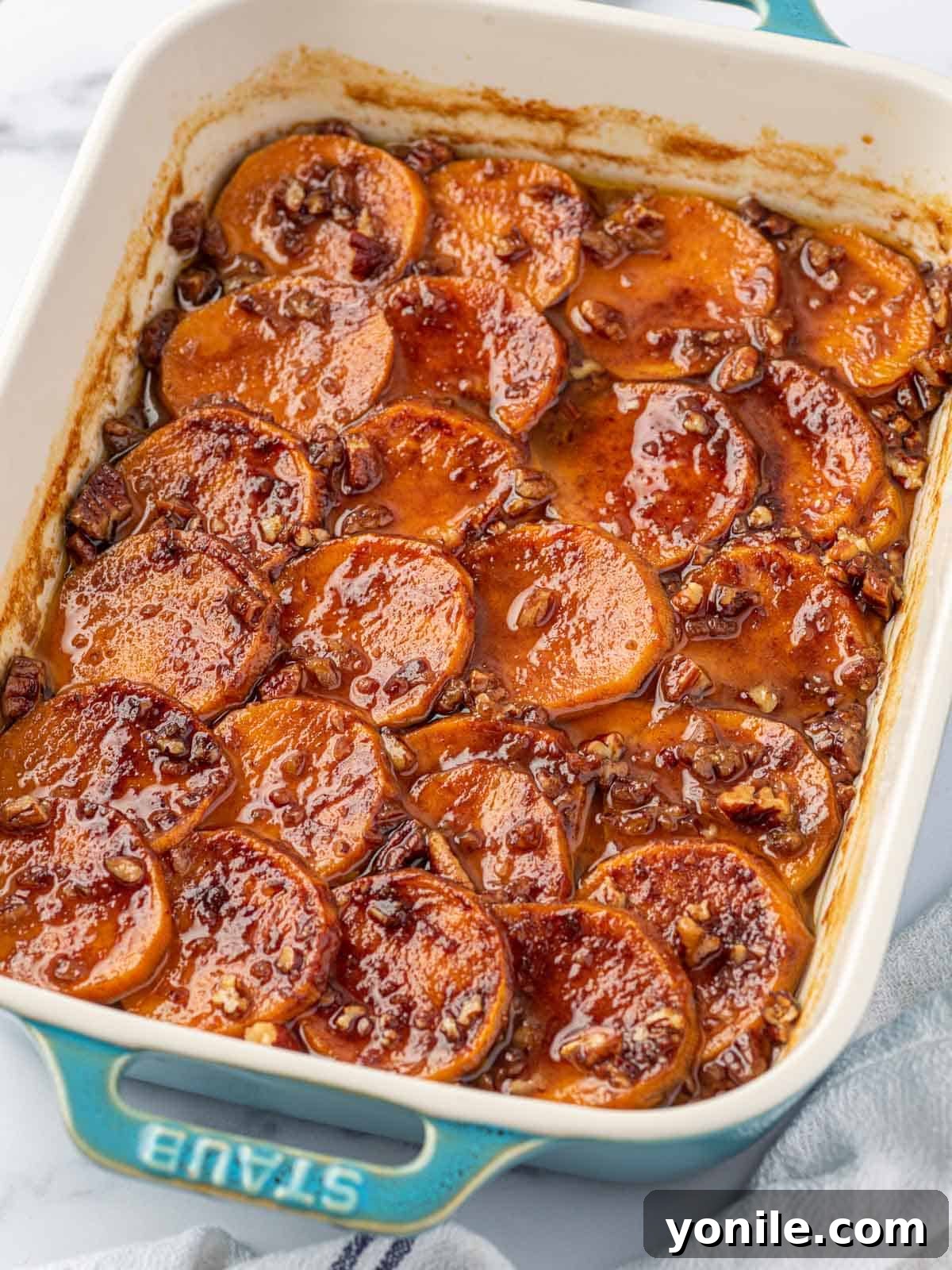 Delicious candied sweet potatoes in a rustic baking dish, ready to be served at a festive gathering