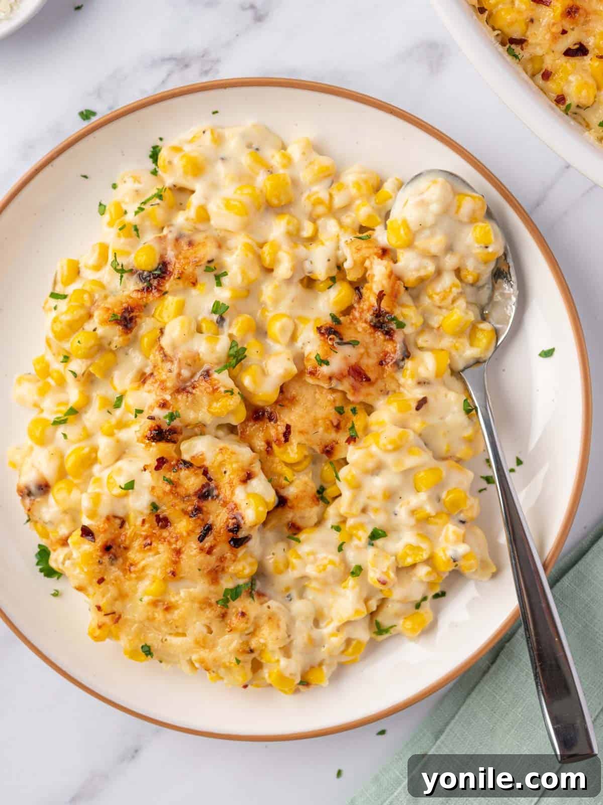 creamed corn casserole in a plate, ready to be eaten