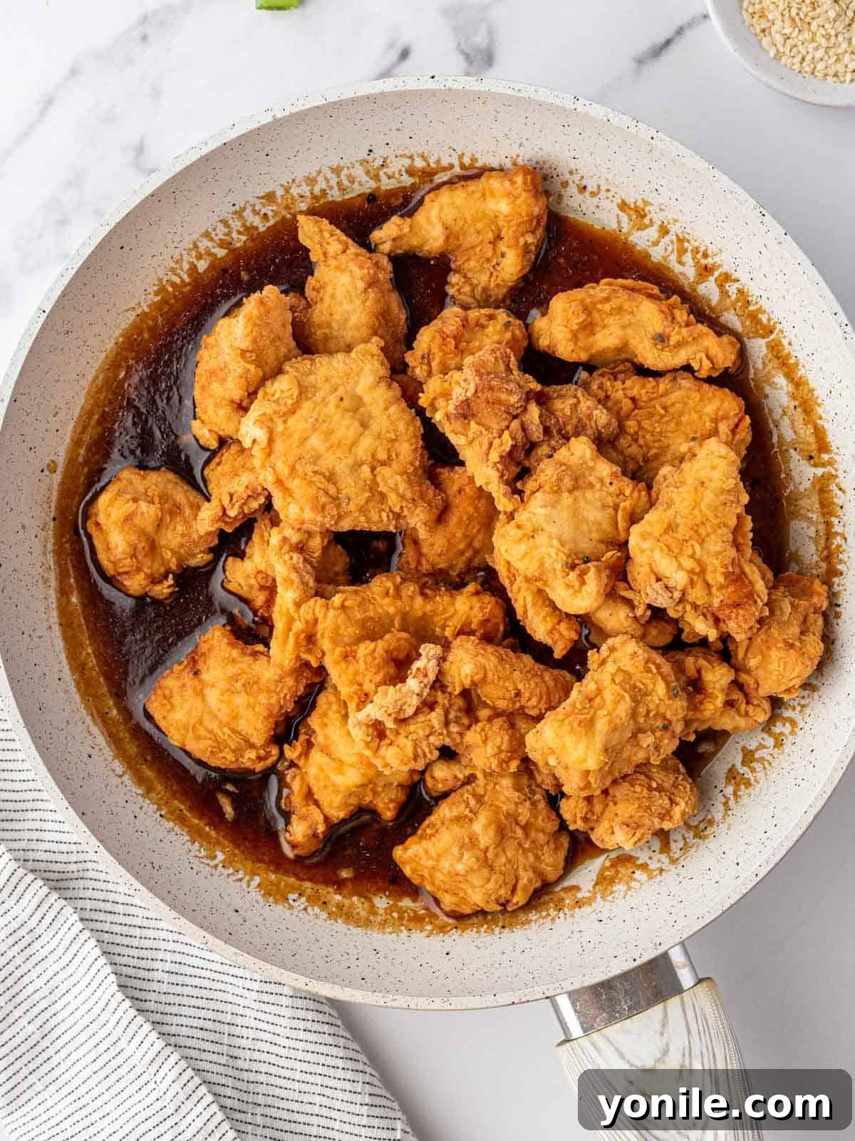 Zesty Lemon Chicken 8 Crispy fried chicken in skillet of Chinese lemon sauce.