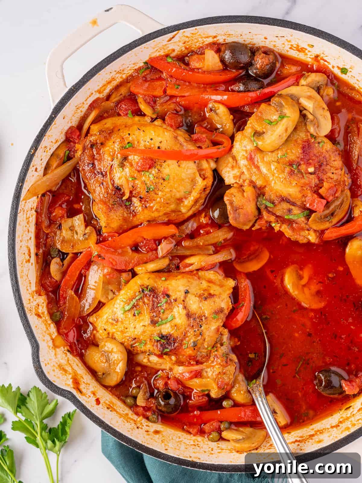 Classic Italian Hunter's Chicken 11 A full skillet of stovetop chicken cacciatore, with one serving removed, highlighting its family-style presentation.