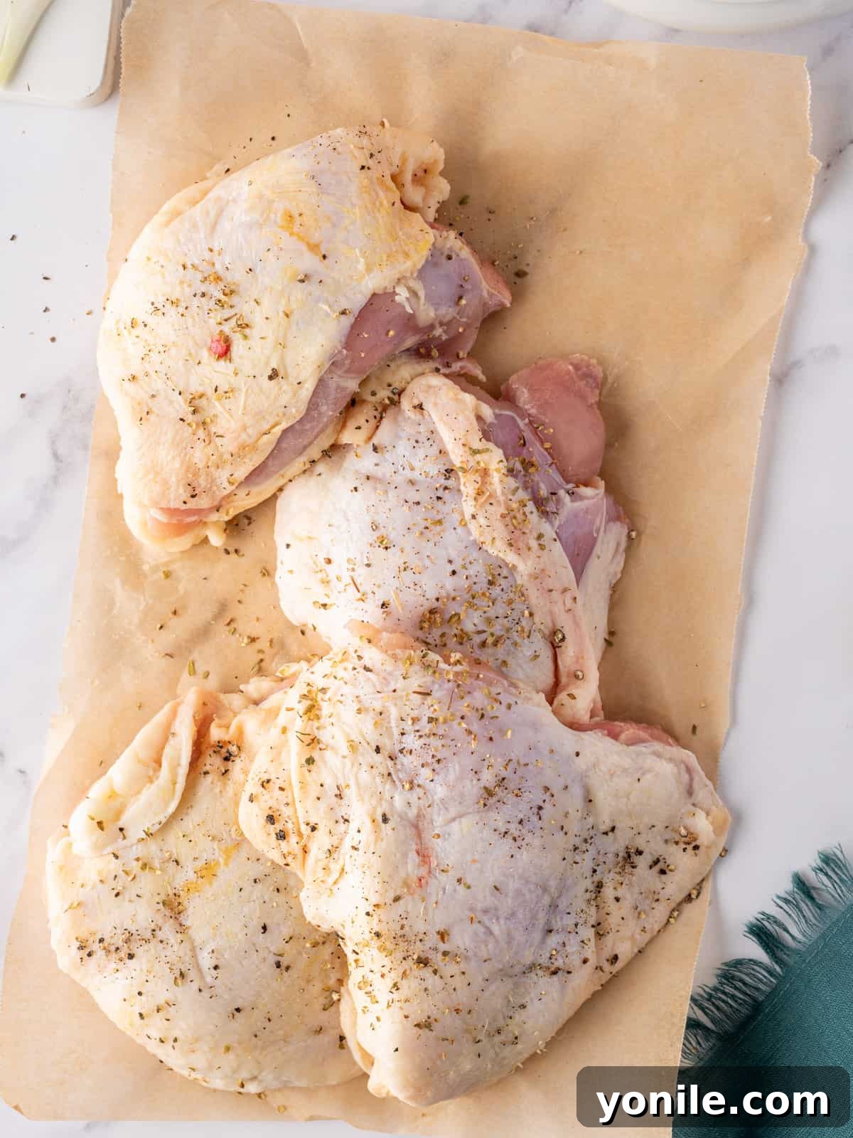 Classic Italian Hunter's Chicken 4 Bone-in, skin-on chicken thighs perfectly seasoned with Italian herbs, salt, and pepper, ready for searing.