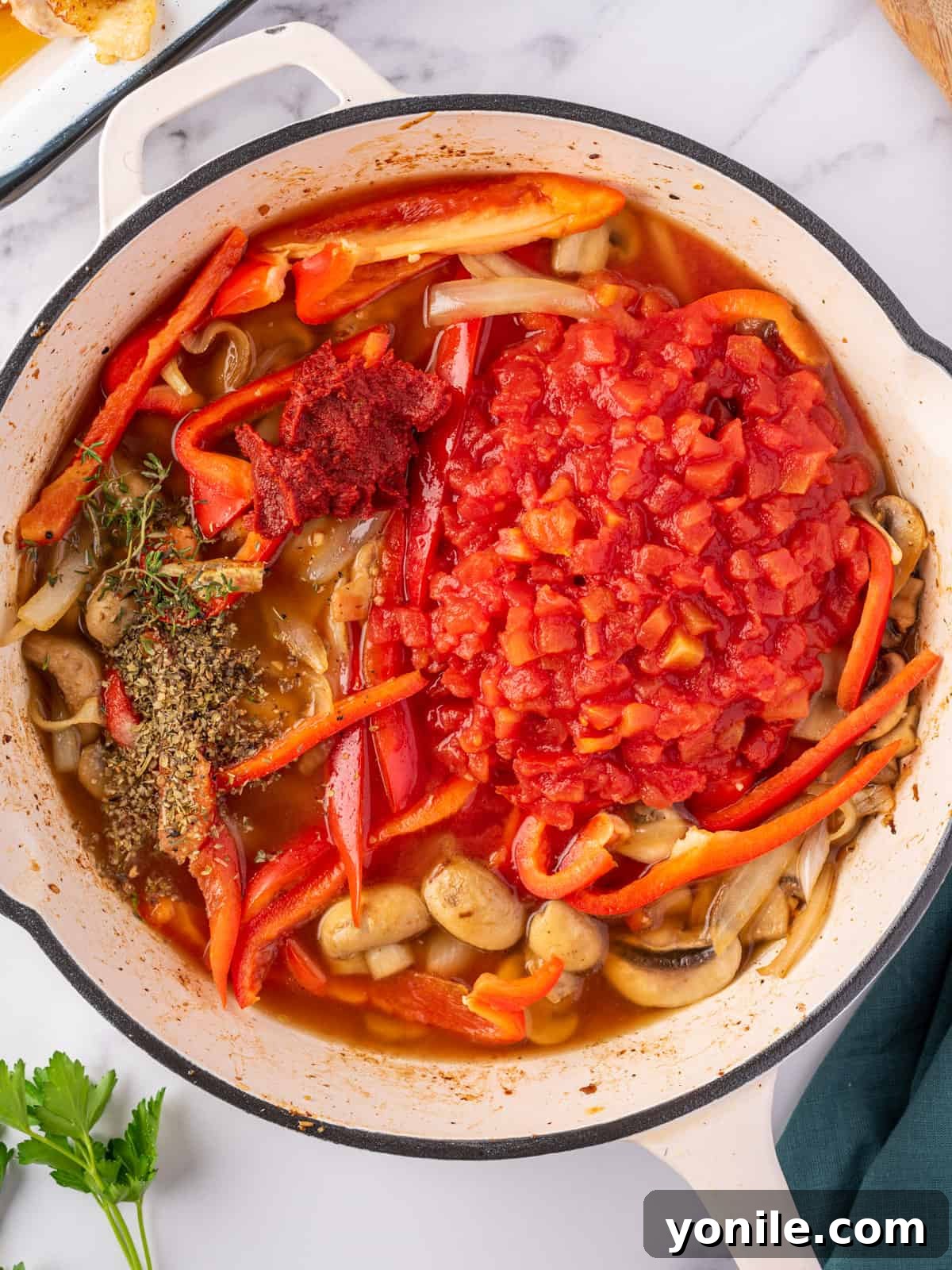 Classic Italian Hunter's Chicken 7 The vibrant, simmering sauce for easy chicken cacciatore, made with tomatoes, herbs, and chicken stock.