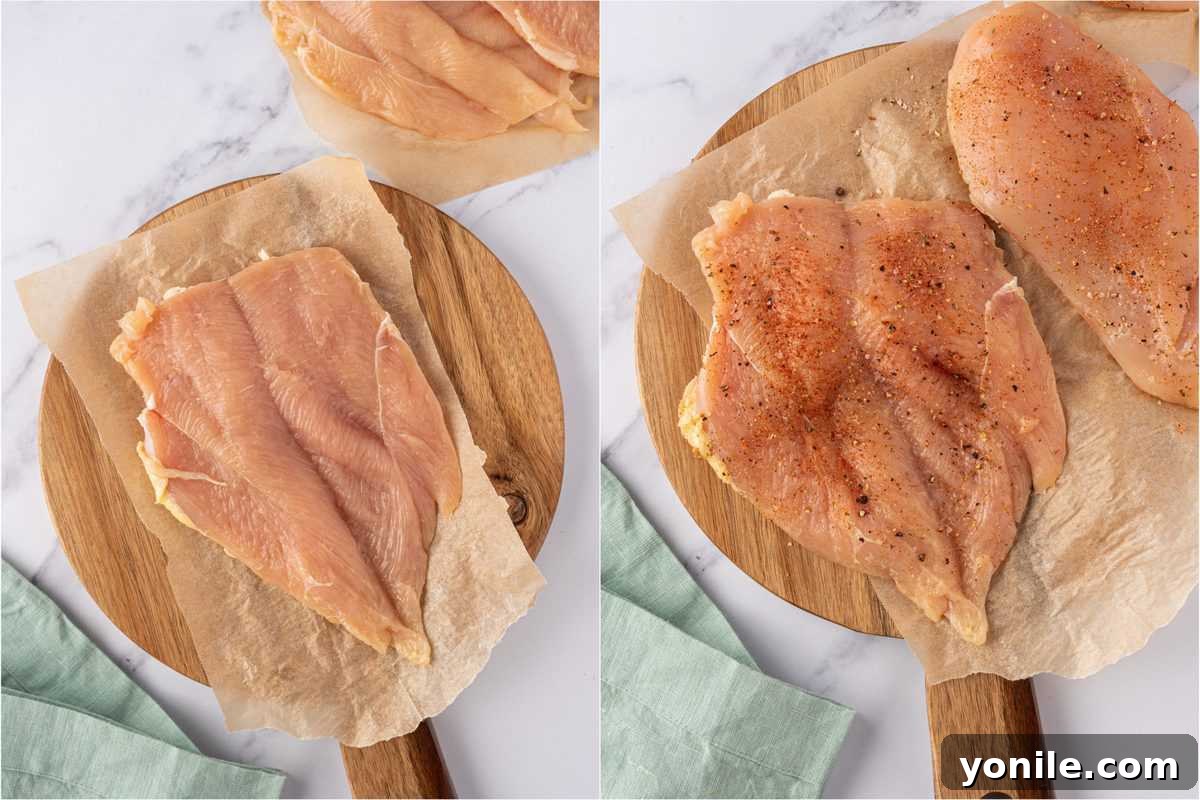 A marinated chicken breast, butterflied to create a pocket for stuffing, showing its readiness for the filling.