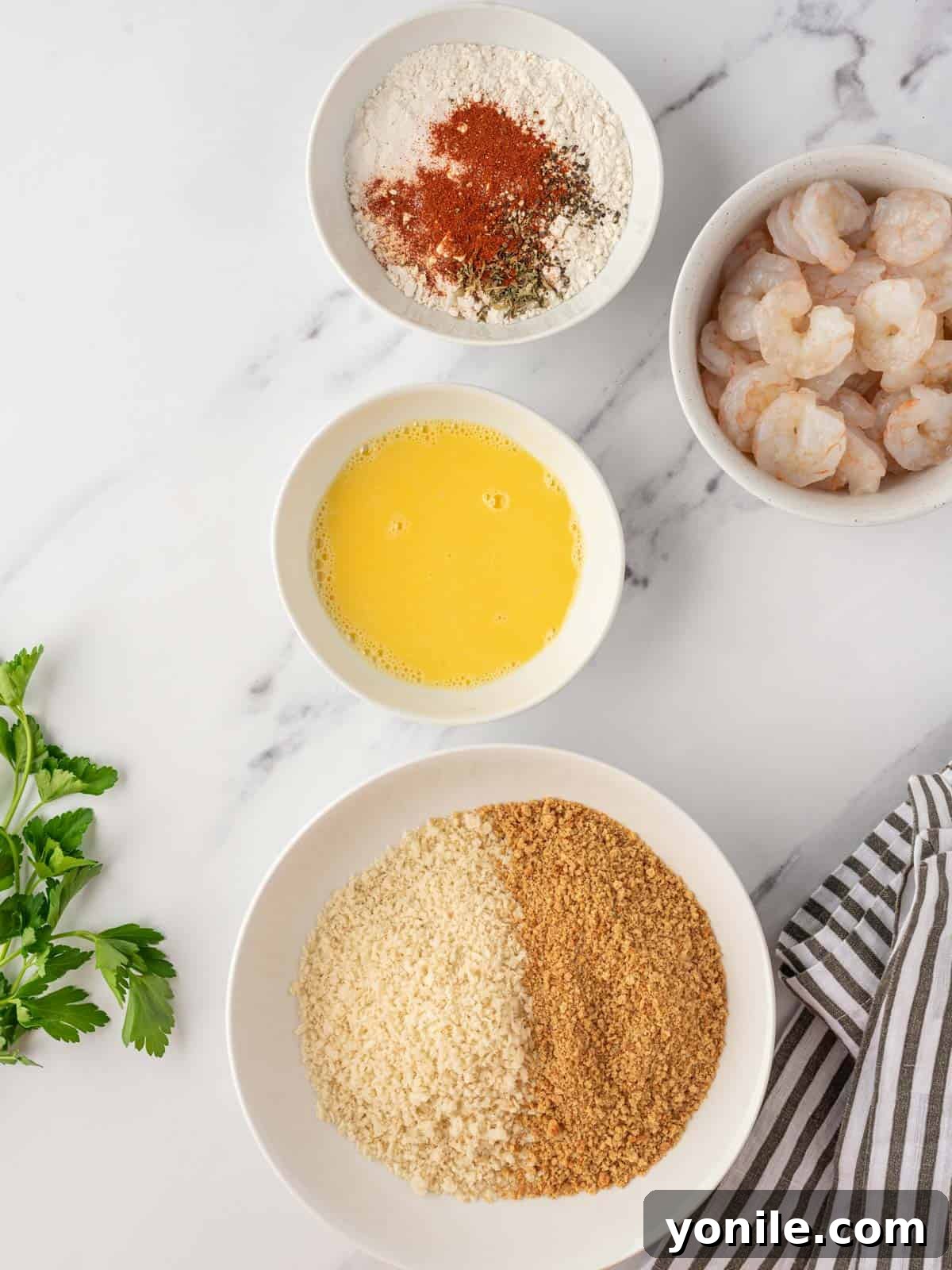 Ingredients needed for breading homemade popcorn shrimp.