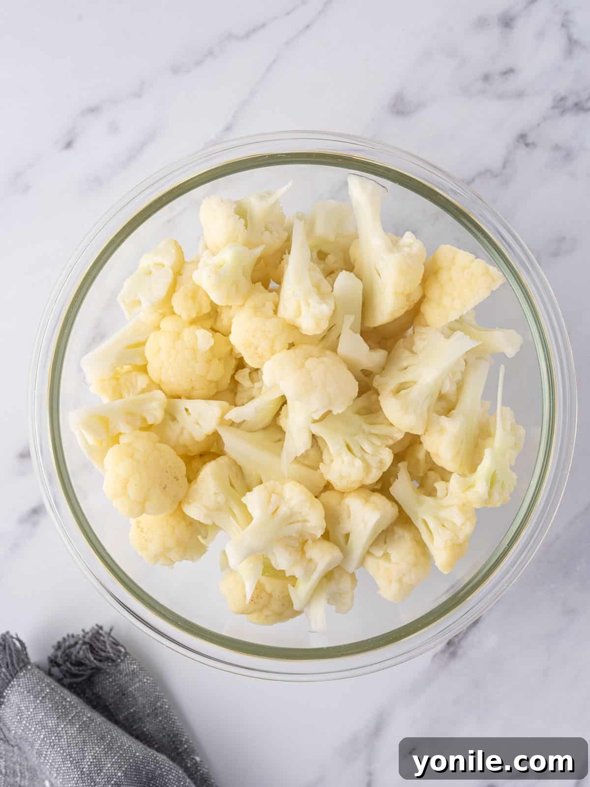 Cooked cauliflower florets in a bowl.