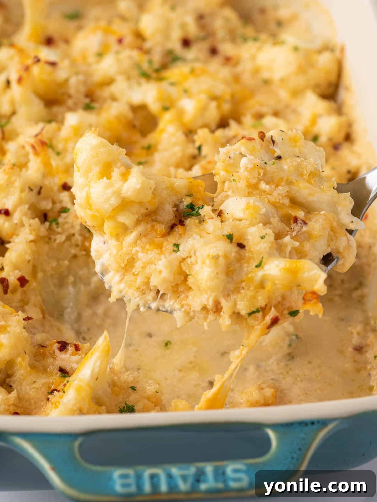 A scoop of cheese cauliflower mac and cheese.