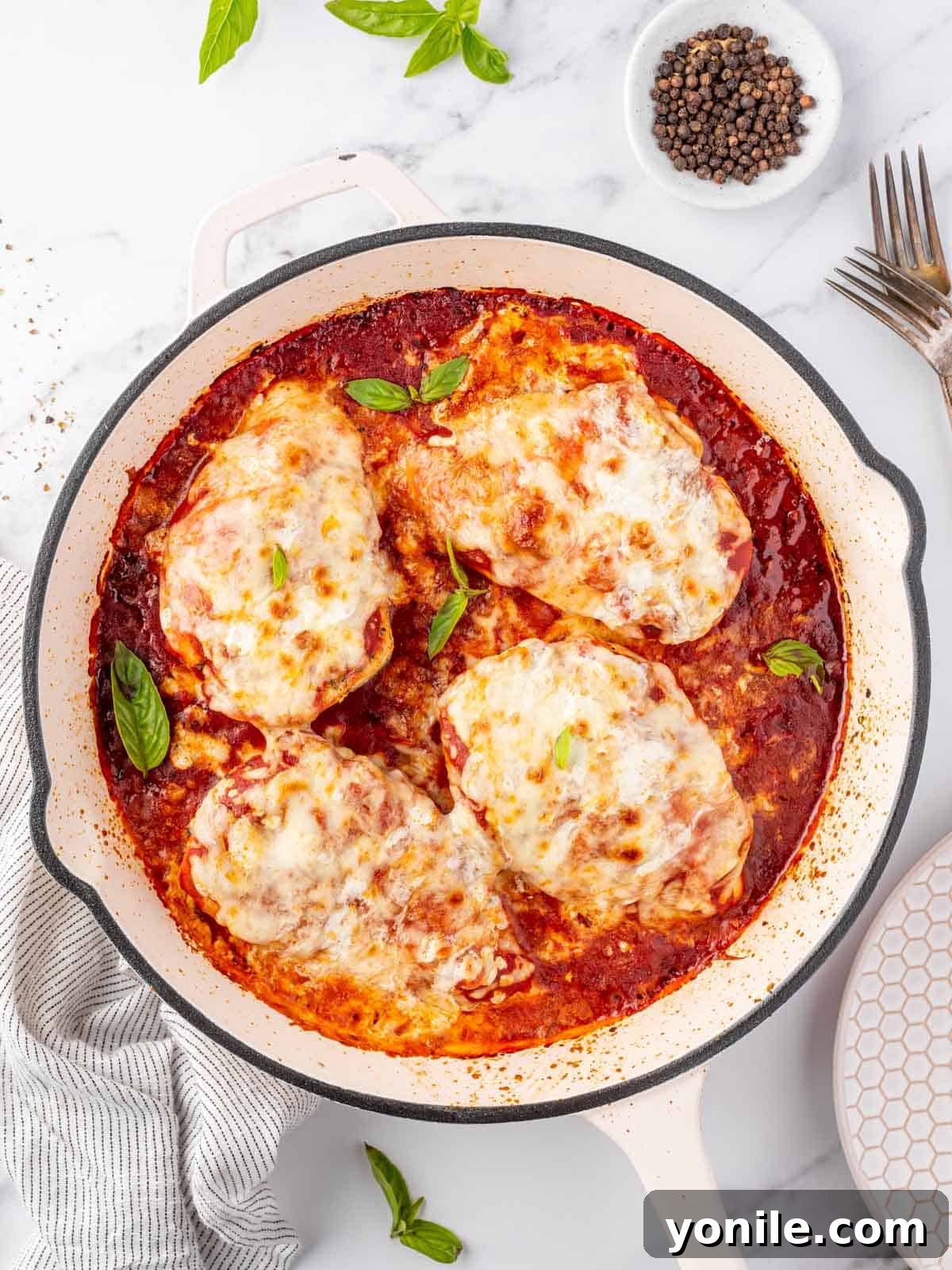 Overhead view of a pan with chicken parmesan.
