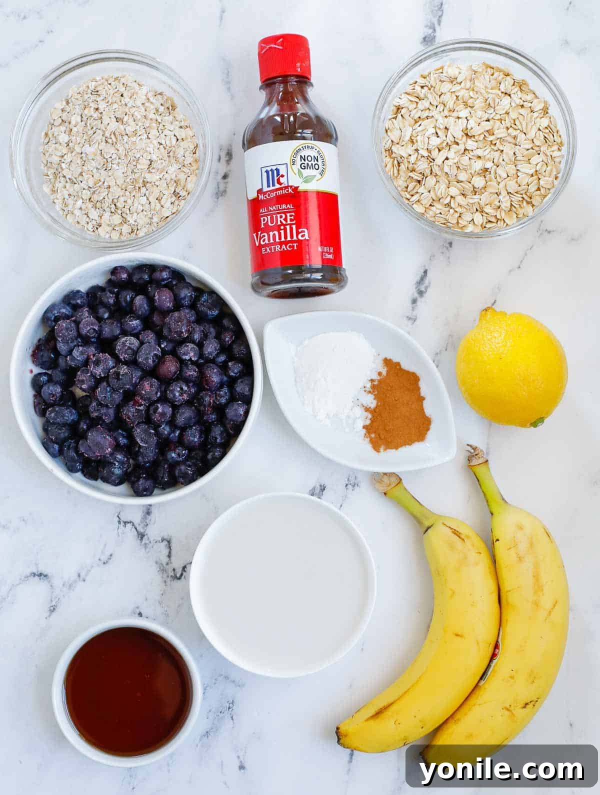 Collection of fresh ingredients for blueberry oatmeal bake arranged neatly on a counter.