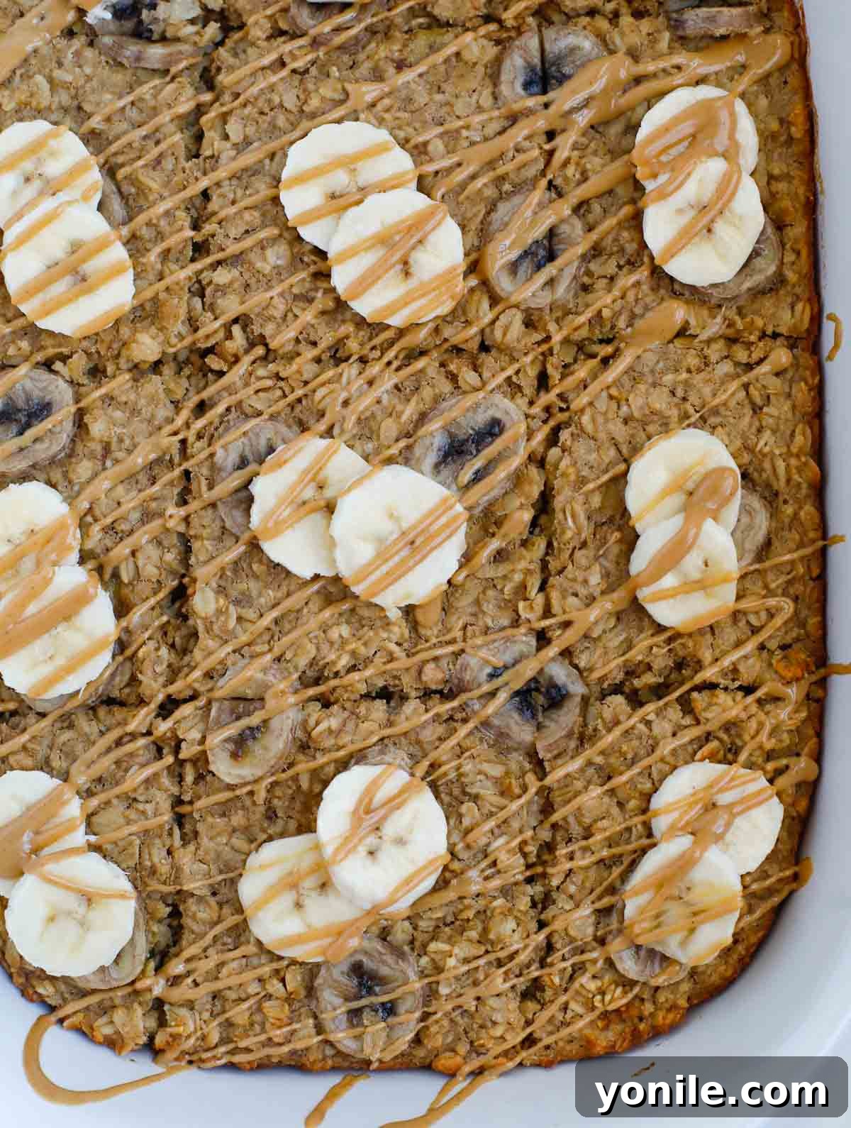 Banana Peanut Butter Baked Oatmeal sliced in a serving dish.