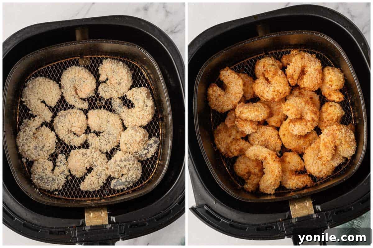 Crispy, breaded shrimp cooking in an air fryer basket, achieving a perfect golden brown as hot air circulates around them.