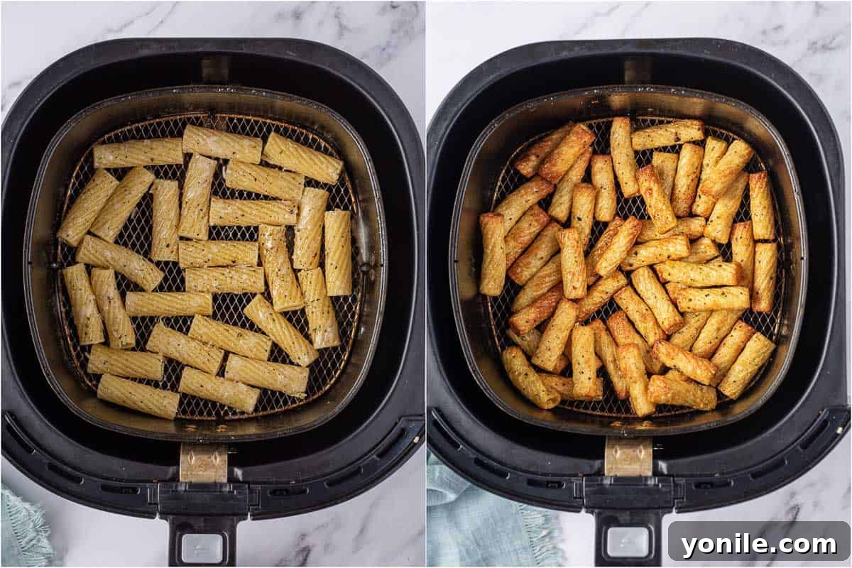 Cooked pasta noodles arranged in a single layer in an air fryer basket.