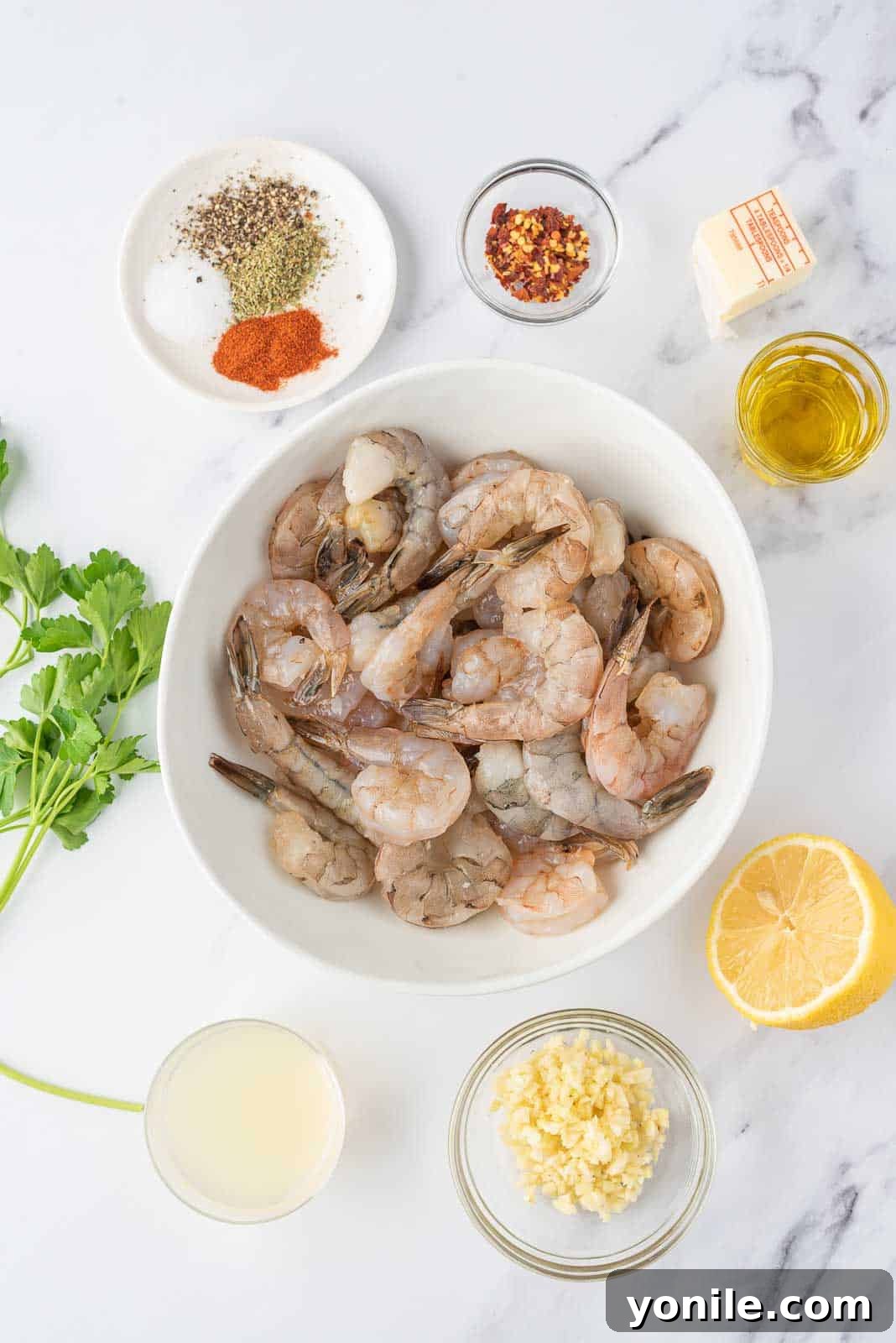 Bright and Buttery Lemon Garlic Shrimp 3 Fresh ingredients laid out for lemon garlic butter shrimp including shrimp, lemons, garlic, butter, and herbs.