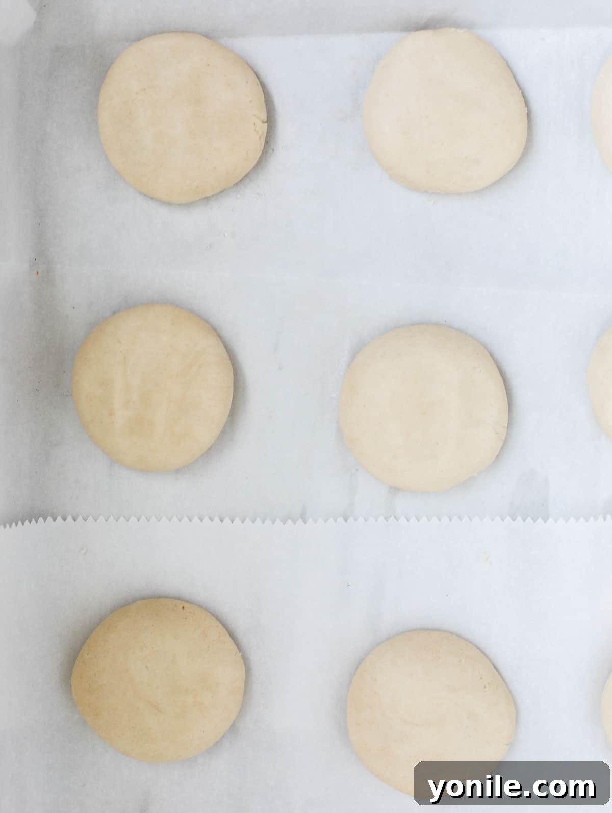 Lebanese Ghraybeh Butter Cookies 6 ghraybeh cookies in a sheet pan before finger indent