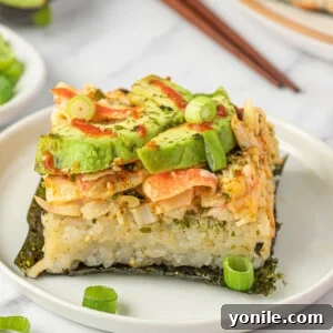 Effortless Baked Sushi 12 A piece of sushi bake on nori on a plate.