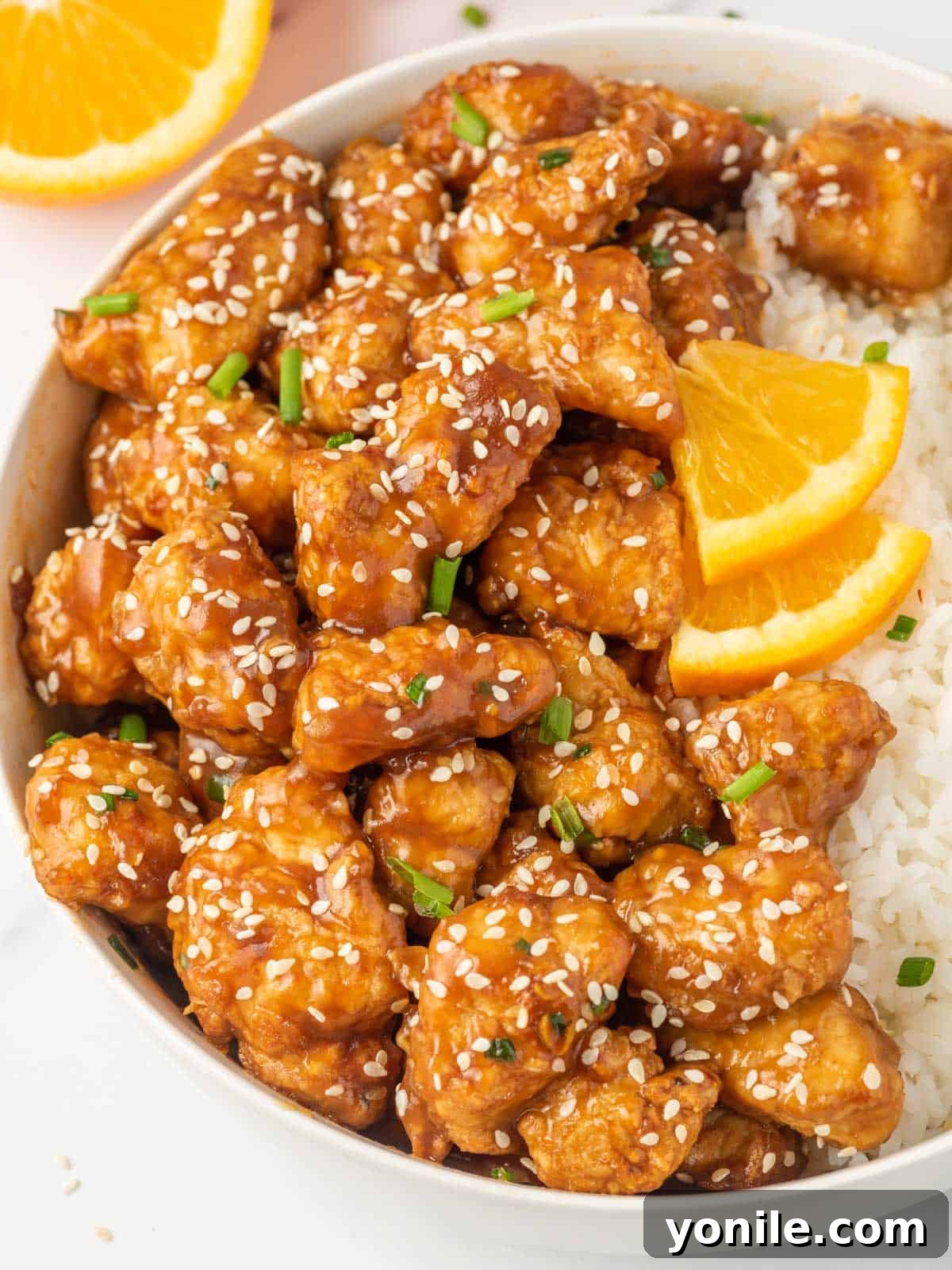 A generous serving of crispy air fryer orange chicken with rice, ready to be enjoyed.