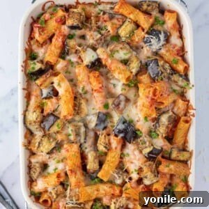 Top view of an eggplant casserole, showcasing the melted cheese and pasta.