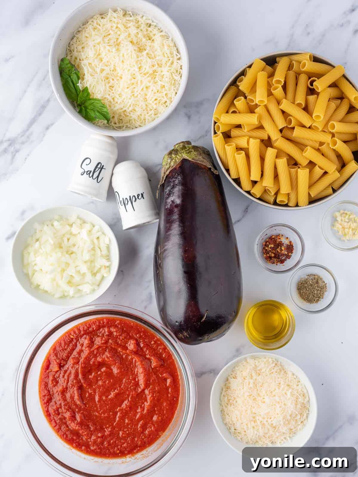 A collage of ingredients for baked eggplant pasta, including rigatoni, eggplant, Diavolo sauce, and cheeses.