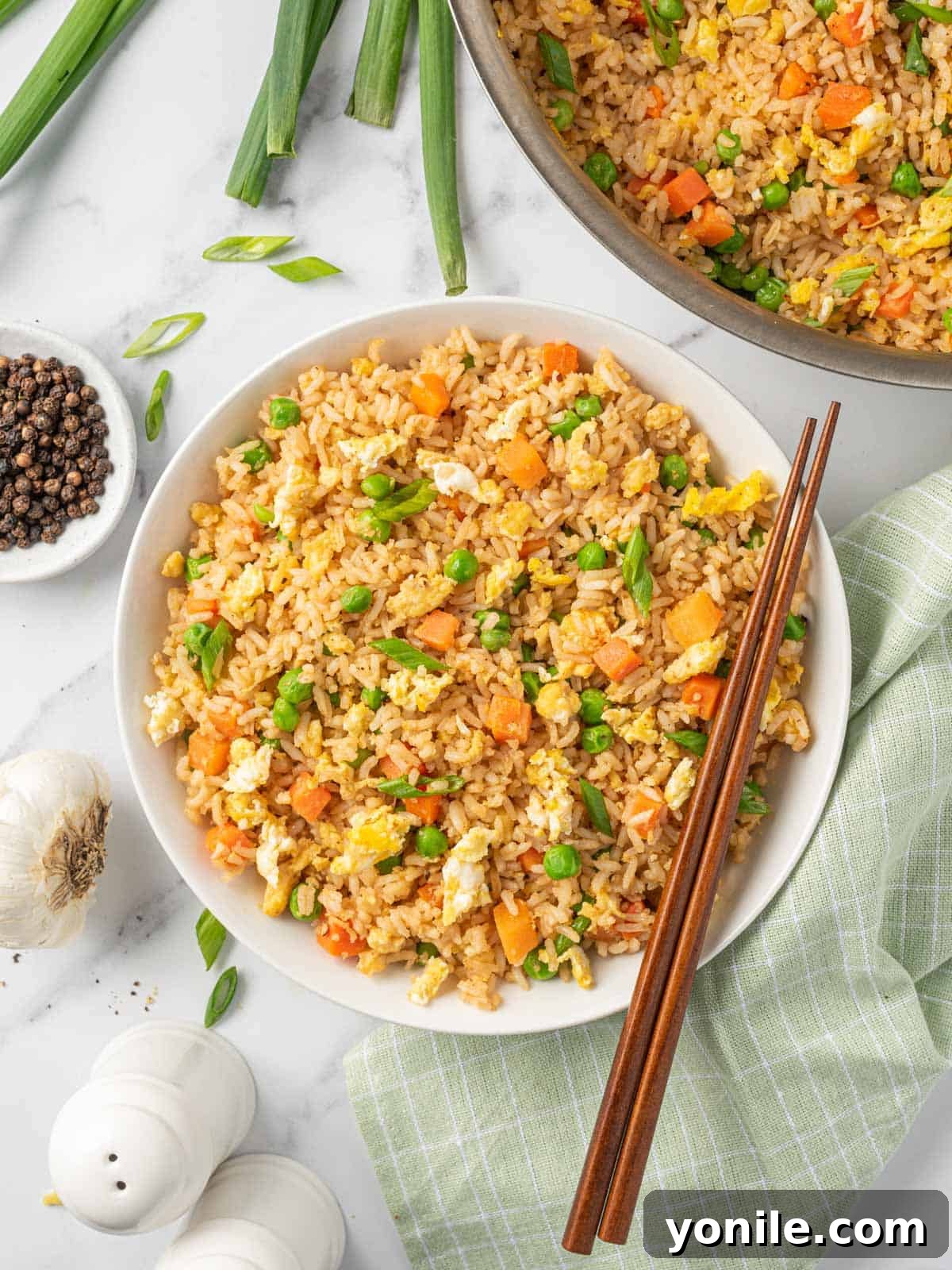 A beautiful bowl of the best Chinese fried rice served with chopsticks.