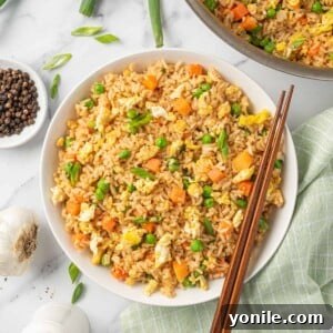 A bowl of the best Chinese fried rice with chopsticks, ready to eat.
