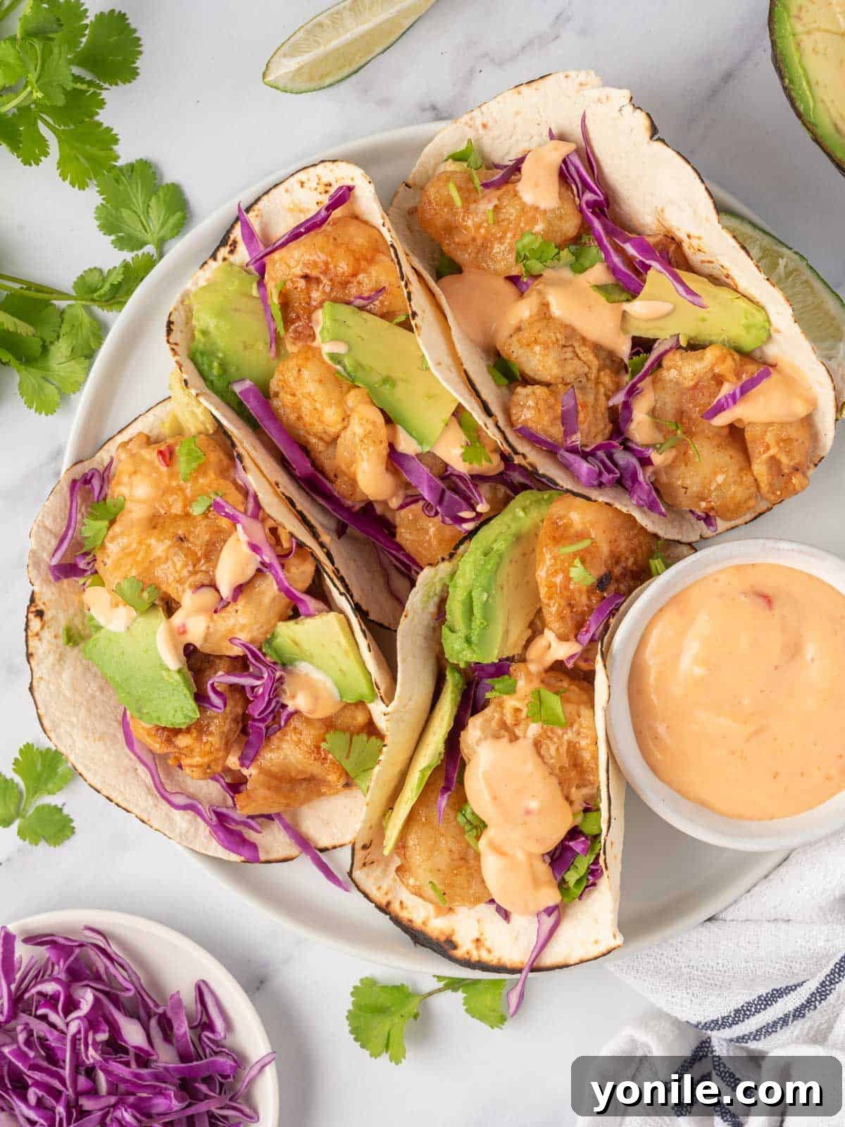 Quickfire Dynamite Shrimp Tacos 8 A beautifully arranged plate of spicy shrimp tacos with dynamite sauce.