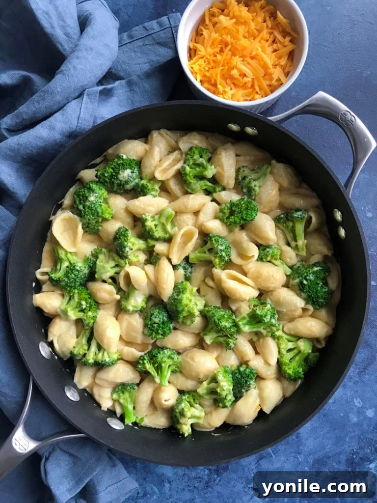 Silky Broccoli Mac 2 Overhead view of creamy broccoli mac and cheese in a skillet, ready to be served.