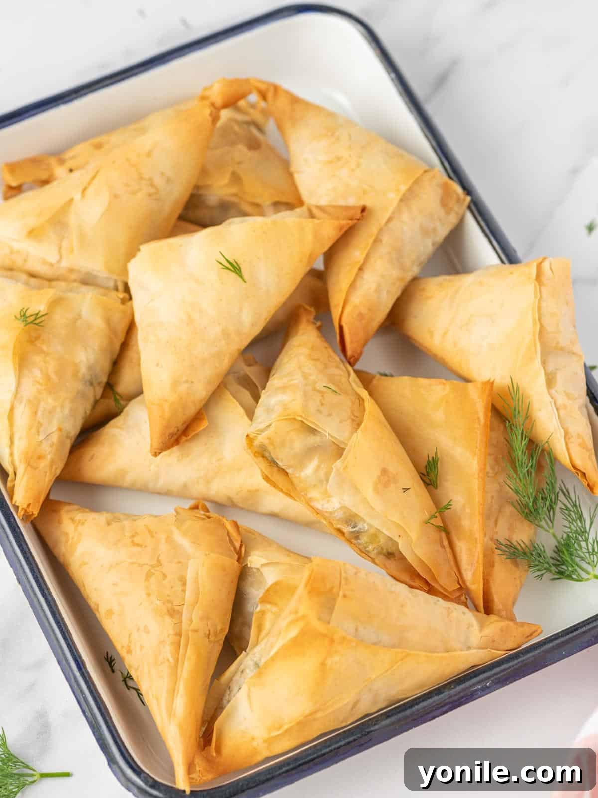 Simple Spanakopita Bites 10 A beautifully presented easy spanakopita recipe on a serving tray, perfect for any gathering.
