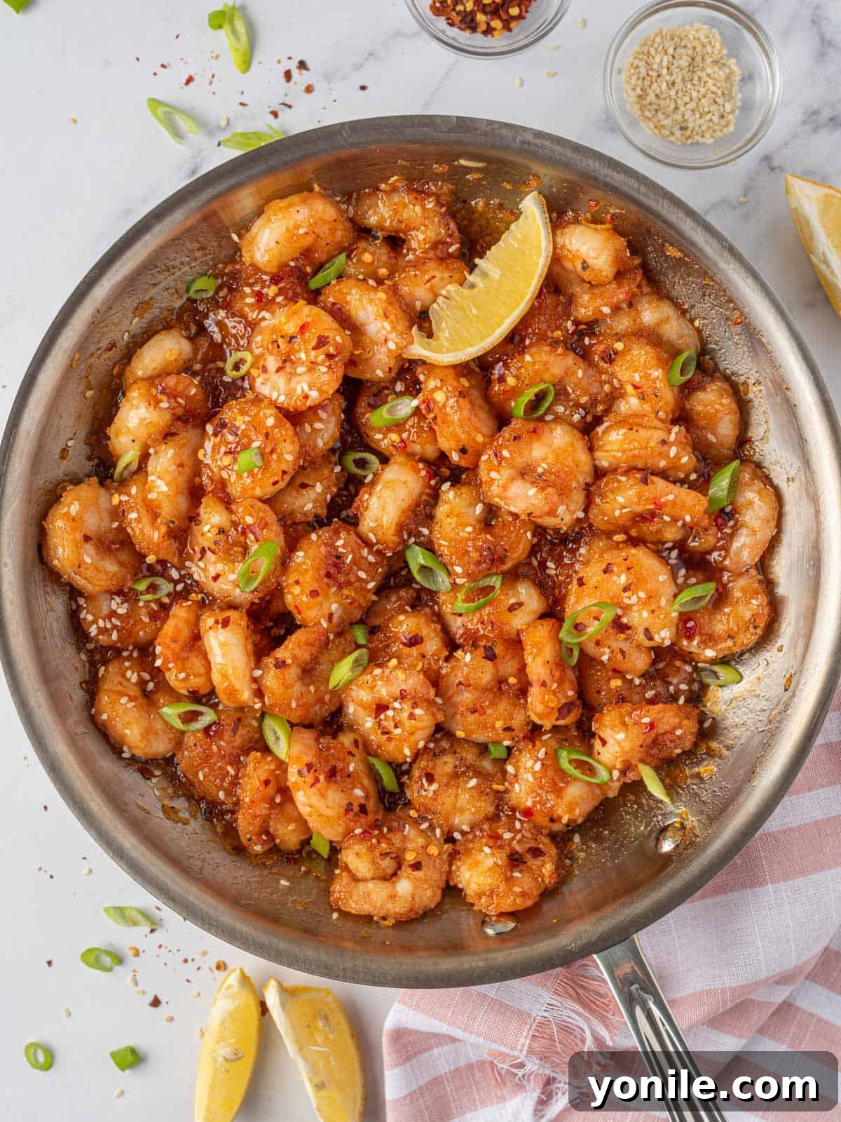 Dynamite Prawns 8 Spicy fried shrimp with firecracker sauce in a skillet.