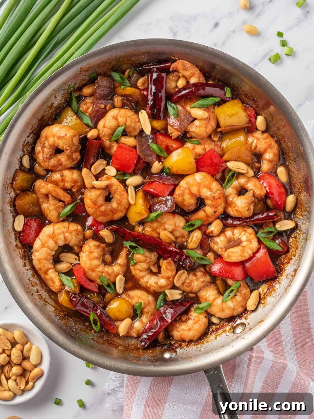 Kung pow shrimp in a skillet to be served.