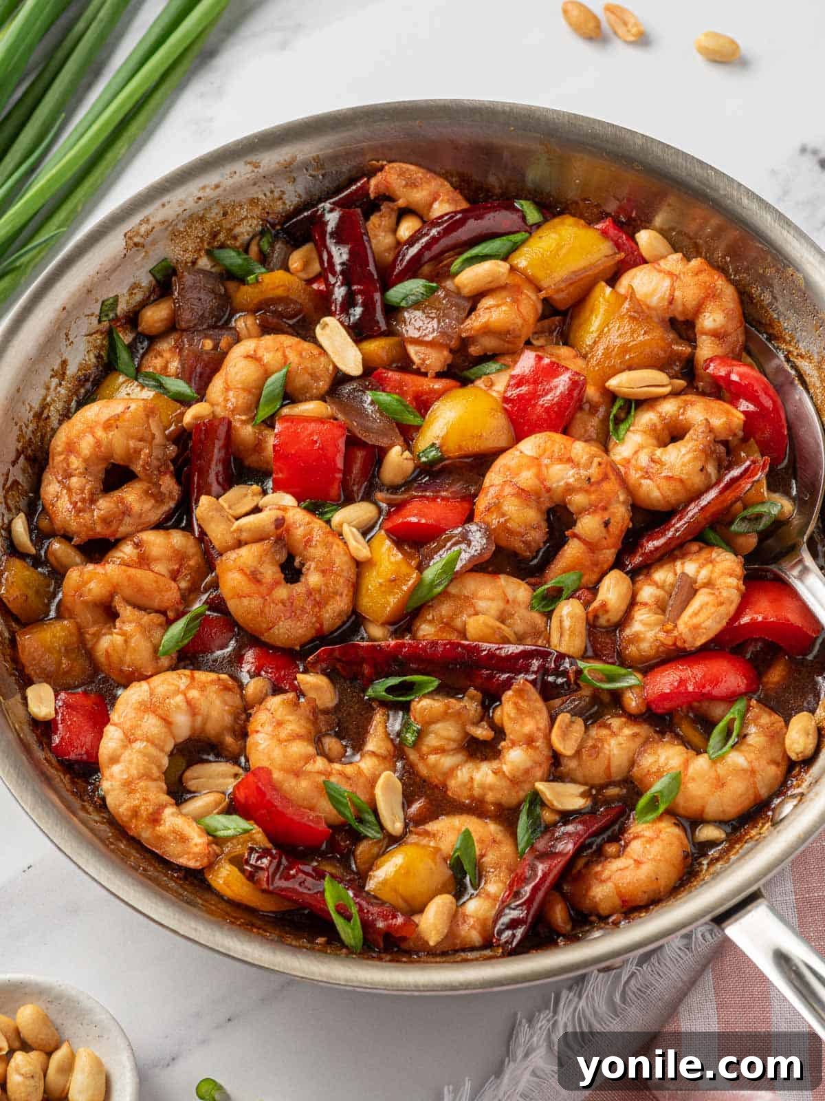 All of the ingredients for Chinese shrimp in a skillet.