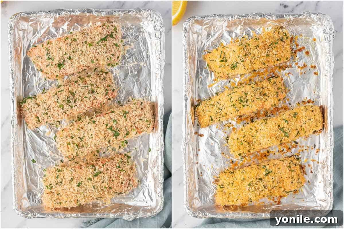 Several parmesan crusted salmon fillets are arranged on a foil-lined baking sheet, ready to be baked to crispy perfection in the oven.