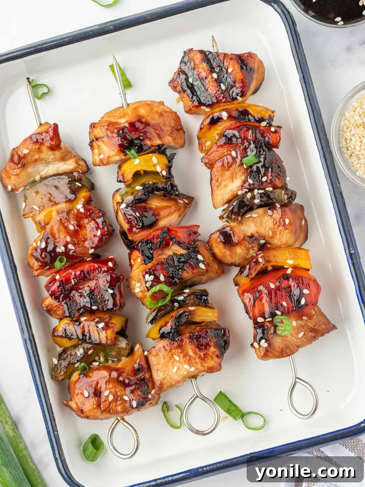Teriyaki Glazed Chicken Skewers 8 Grilled chicken teriyaki skewers arranged beautifully on a platter, ready to be served.