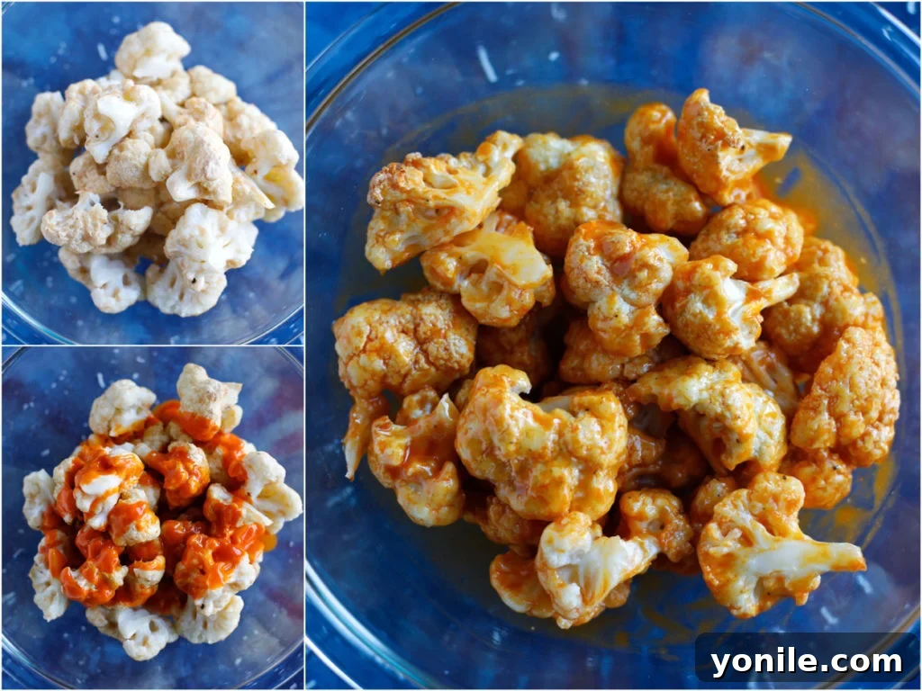 Coating Buffalo Cauliflower Wings in Sauce Baked cauliflower florets being tossed in a vibrant buffalo sauce in a large bowl.