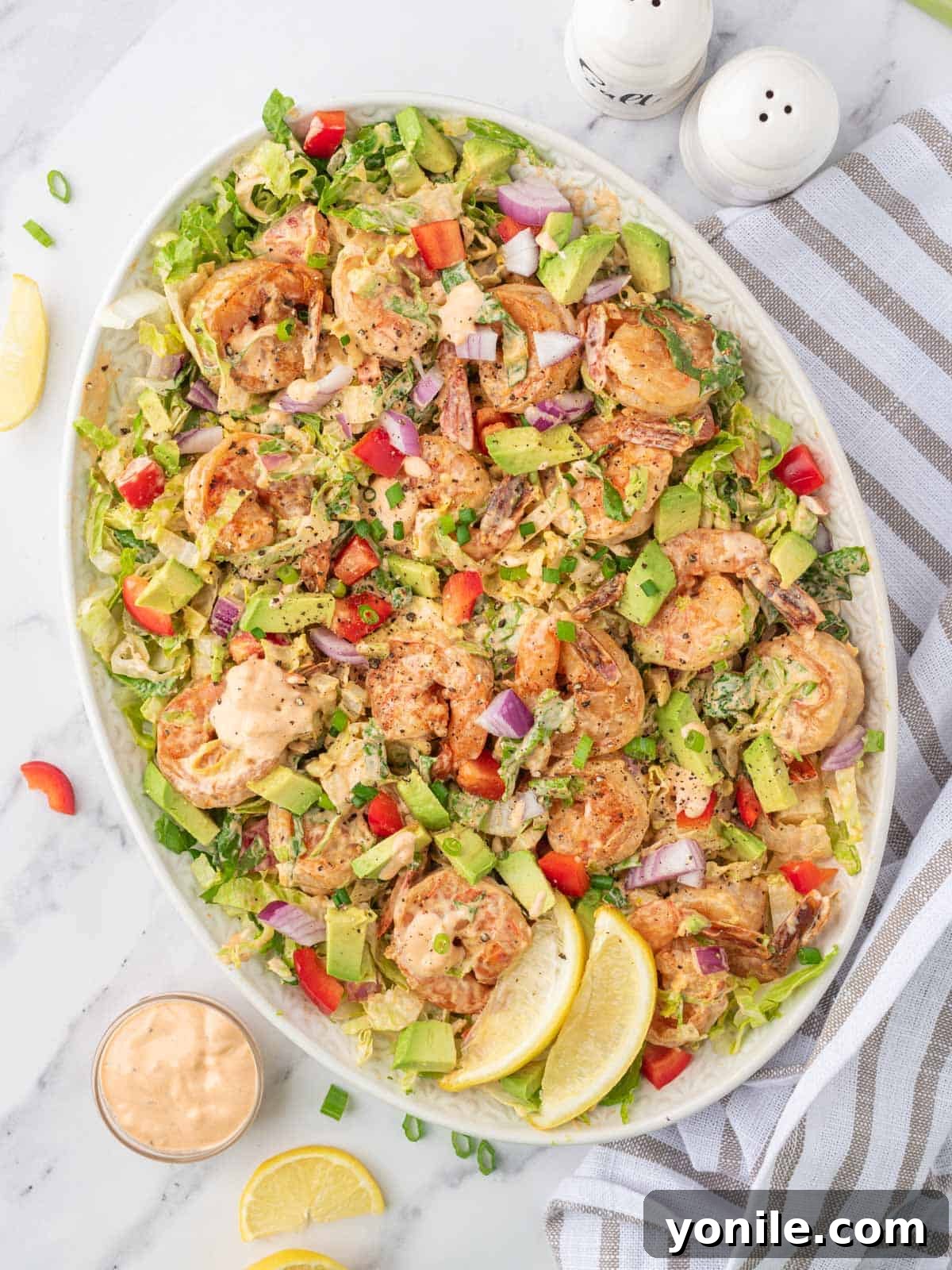 A beautiful platter showcasing a vibrant and easy shrimp lettuce salad, ready to be served and enjoyed.