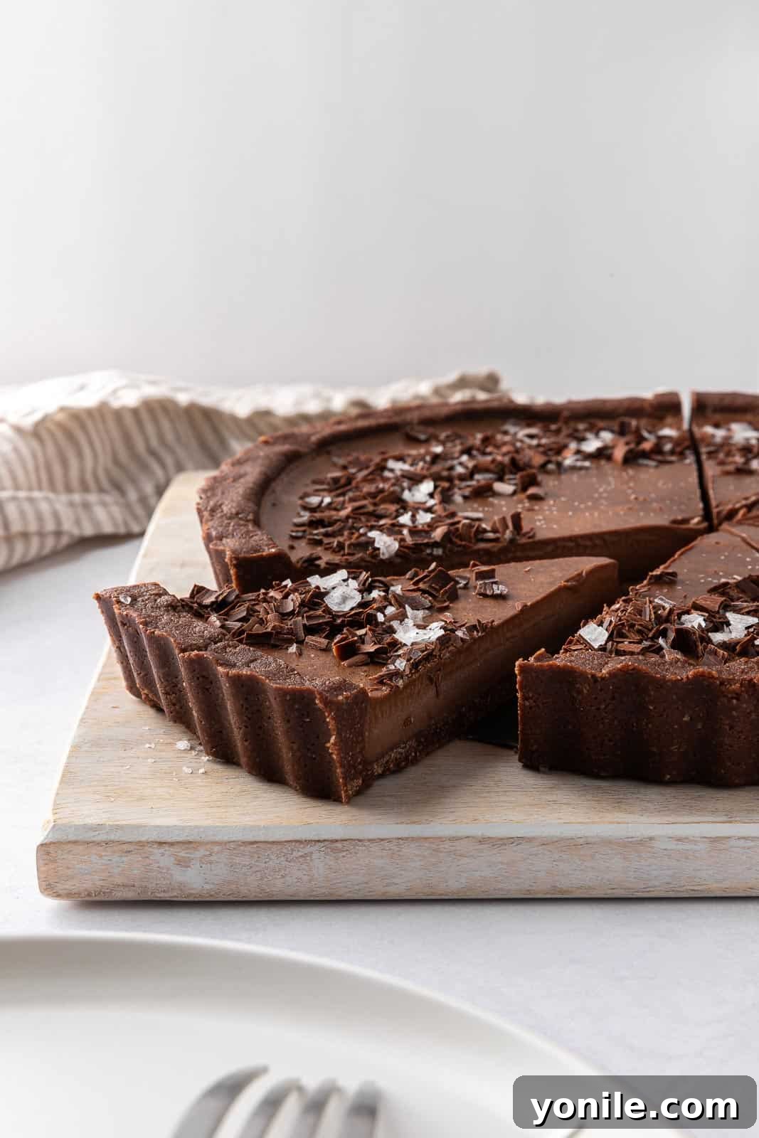 A decadent vegan no-bake pie, beautifully sliced and arranged on a board, ready to be served and enjoyed.