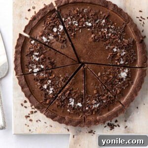 Sliced vegan chocolate pie on a board.