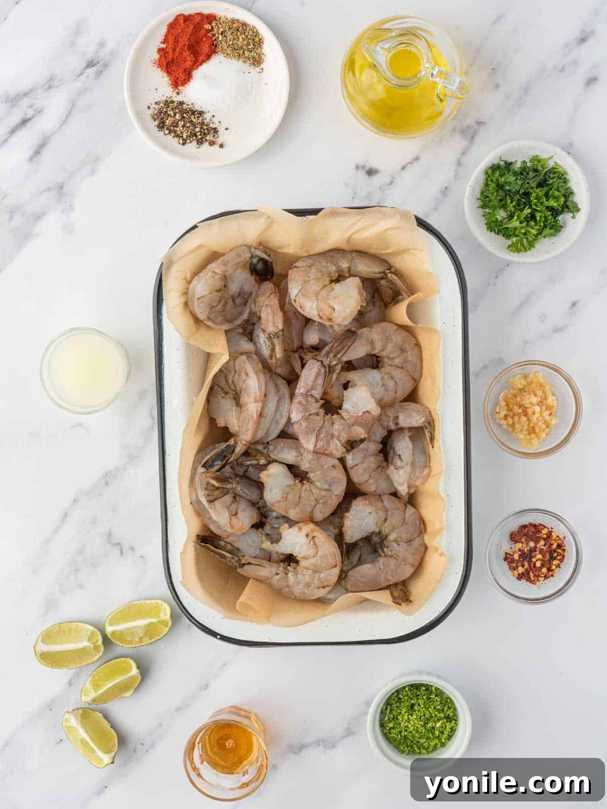 Ingredients needed for zesty grilled shrimp skewers laid out on a kitchen counter.