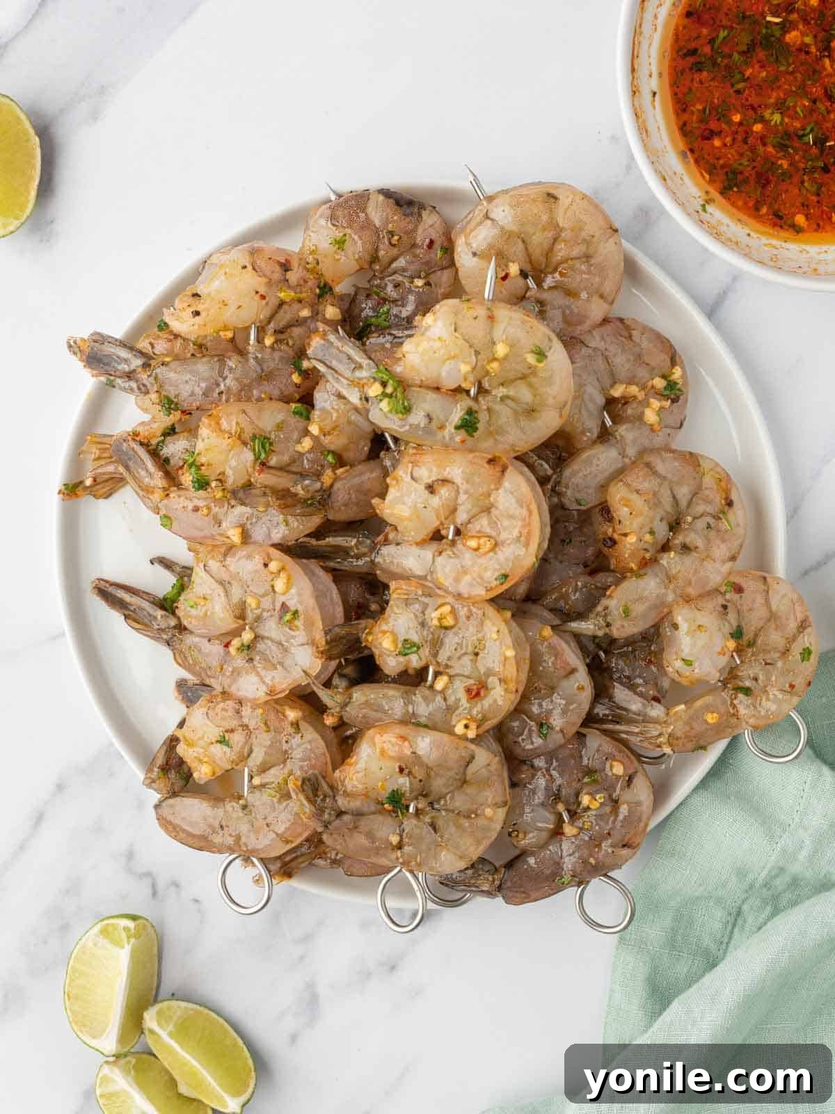 Shrimp skewers with garlic shrimp marinade ready to be placed on the grill.