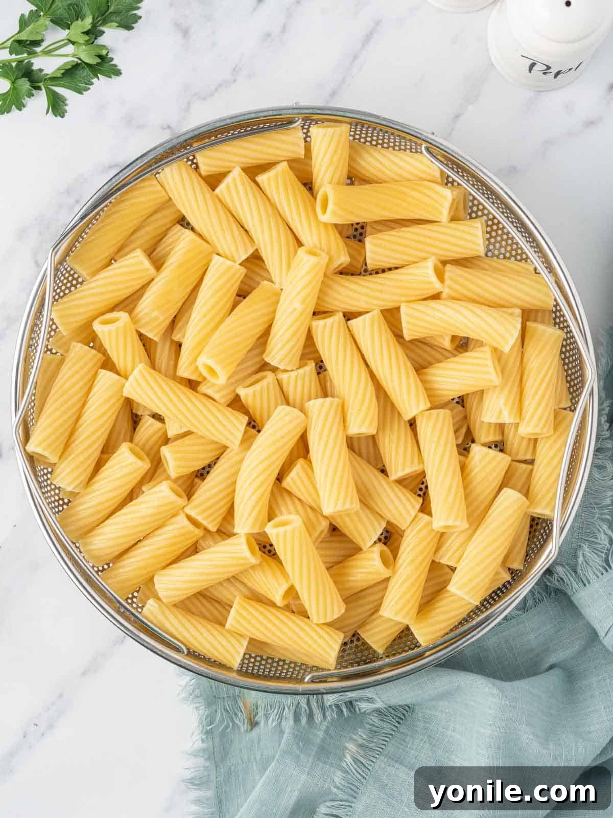 Velvety Tuna Pasta Casserole 4 Cooked rigatoni noodles in a colander, ready to be added to the sauce.