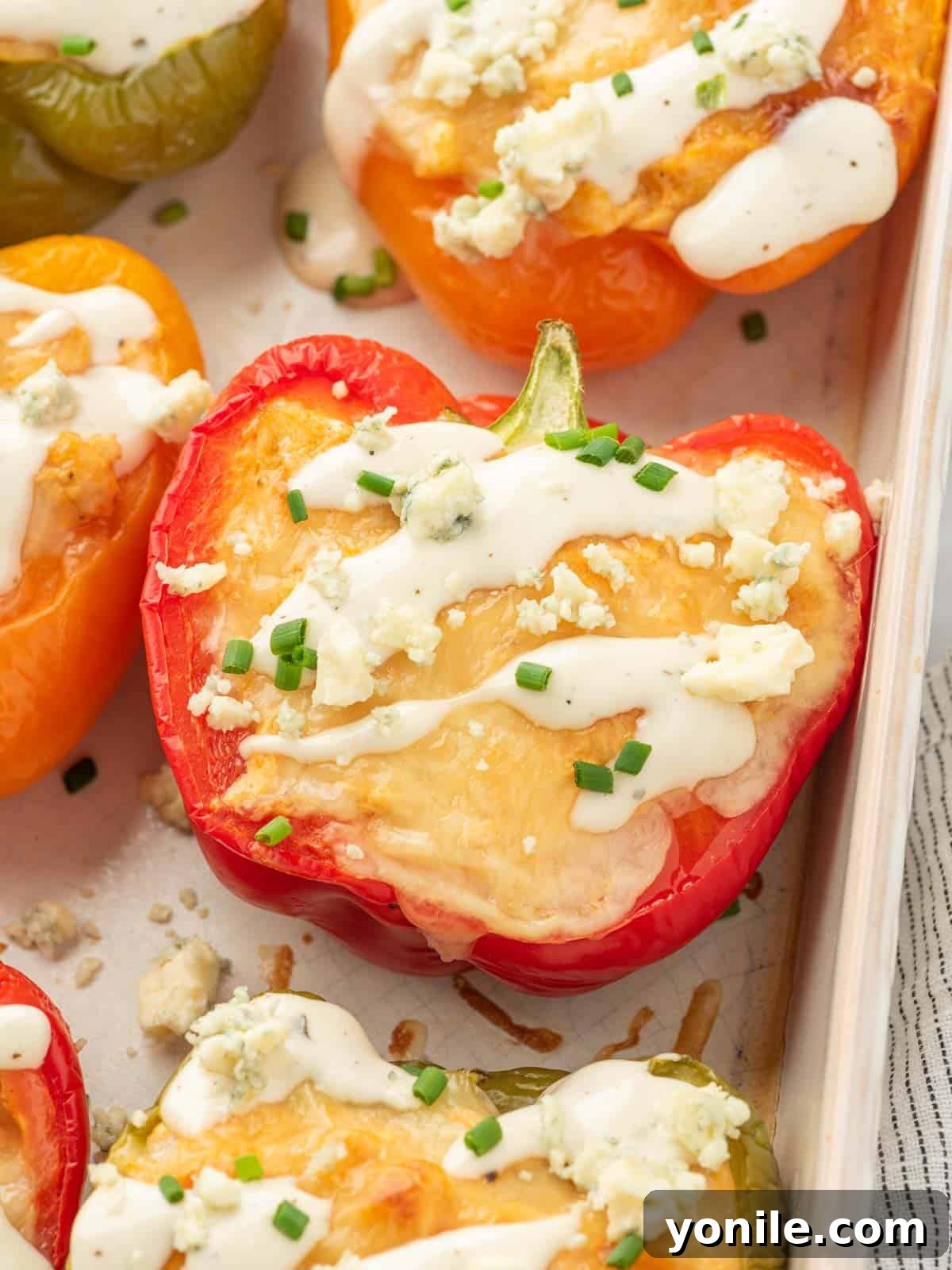 Closeup of buffalo chicken stuffed peppers in a dish.