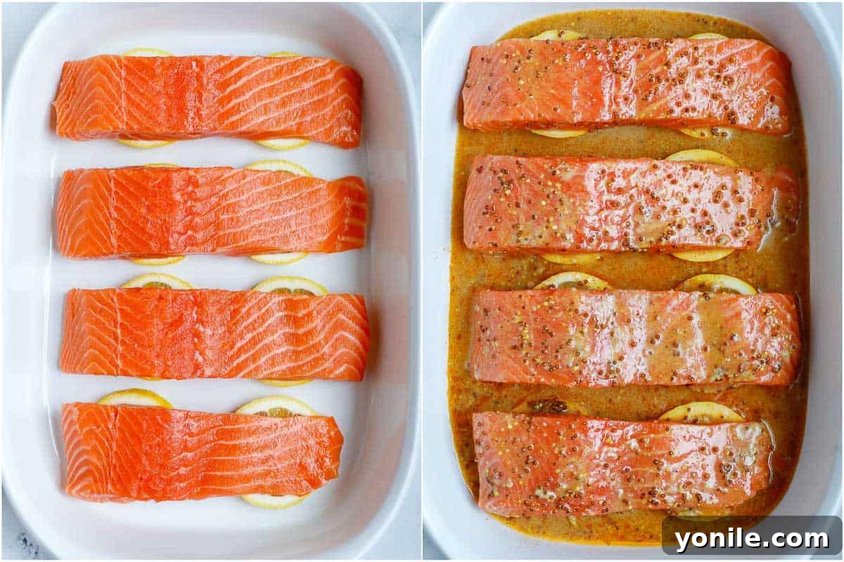 A baking dish showing salmon fillets topped with lemon slices and half of the honey mustard marinade, ready for the oven.