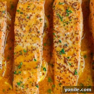 Close-up of healthy baked honey mustard salmon, beautifully glazed and garnished.