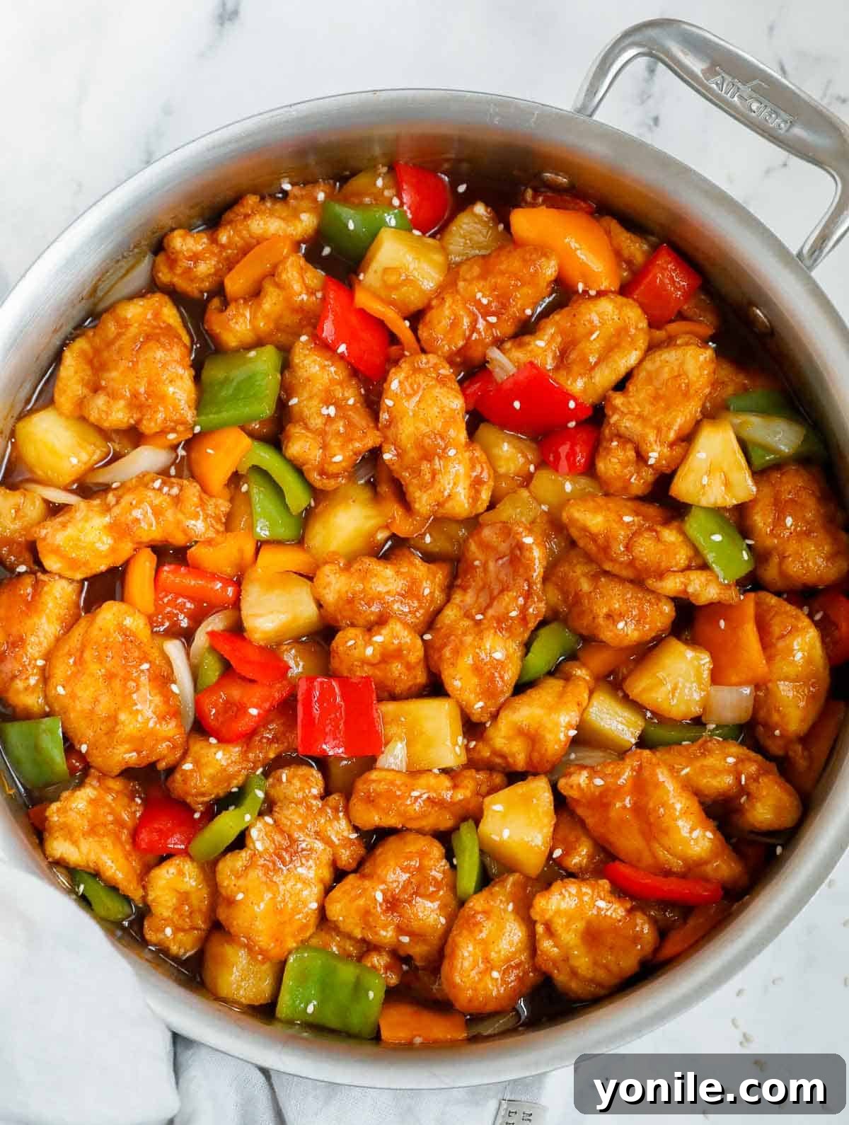 Chicken tossed with easy sweet and sour sauce in a skillet.
