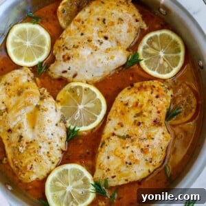 Rosemary lemon chicken breast in a skillet.