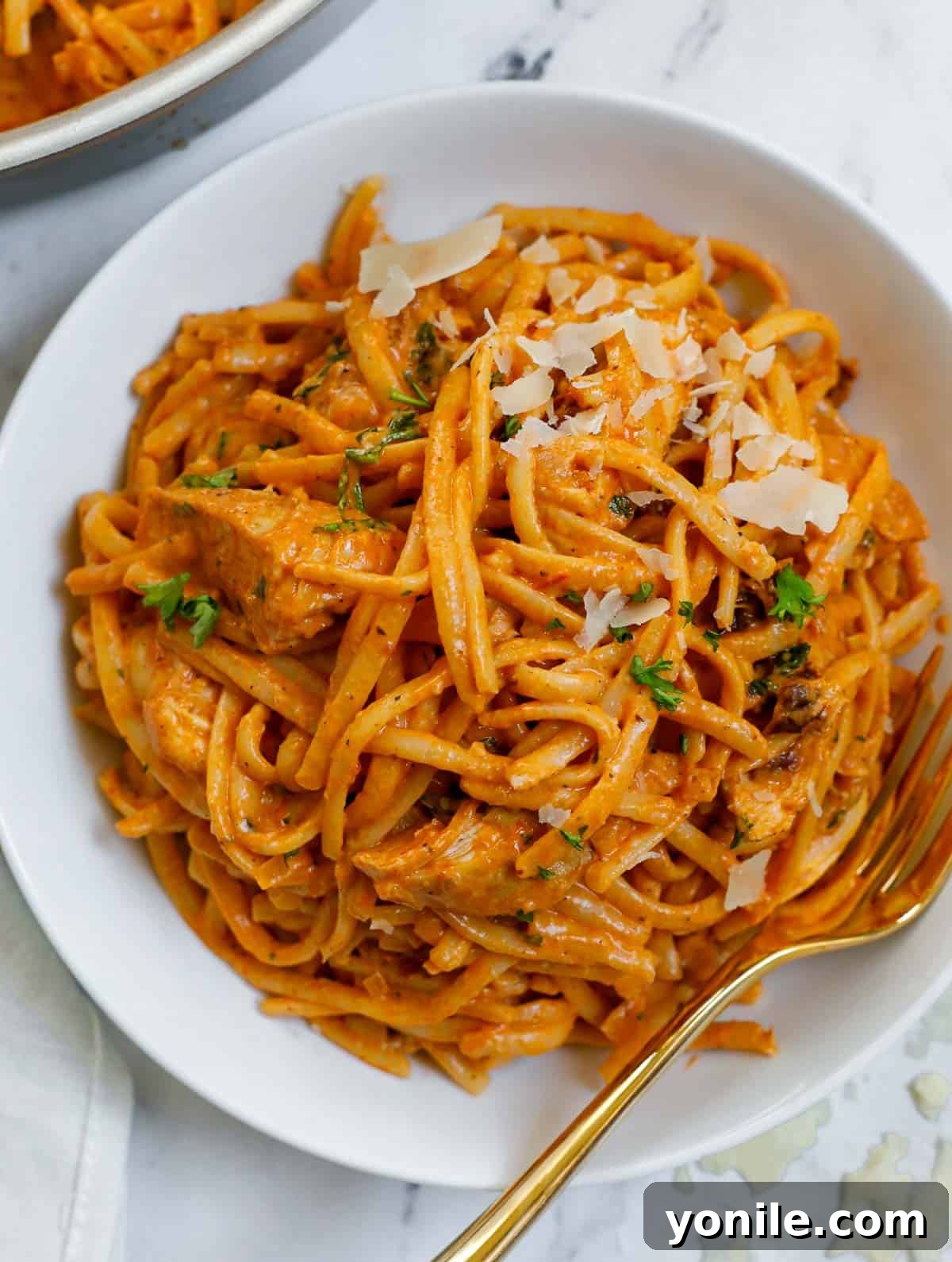 A beautifully presented bowl of creamy spicy chicken linguine, ready to be enjoyed.